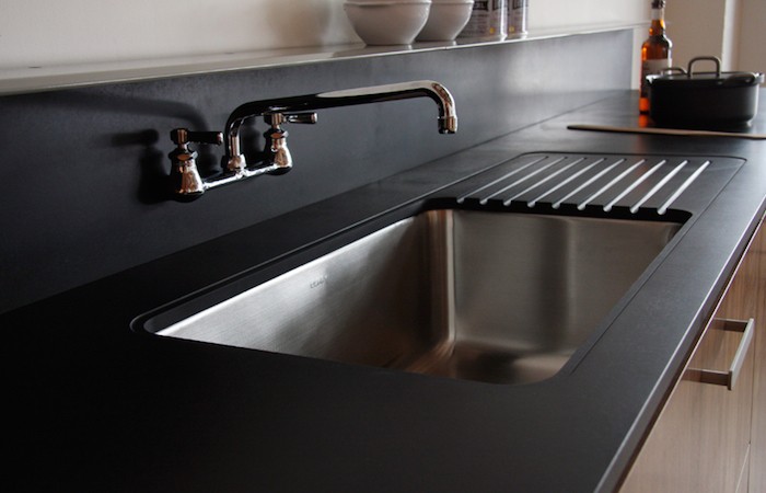 Stainless steel kitchen sink with modern faucet
